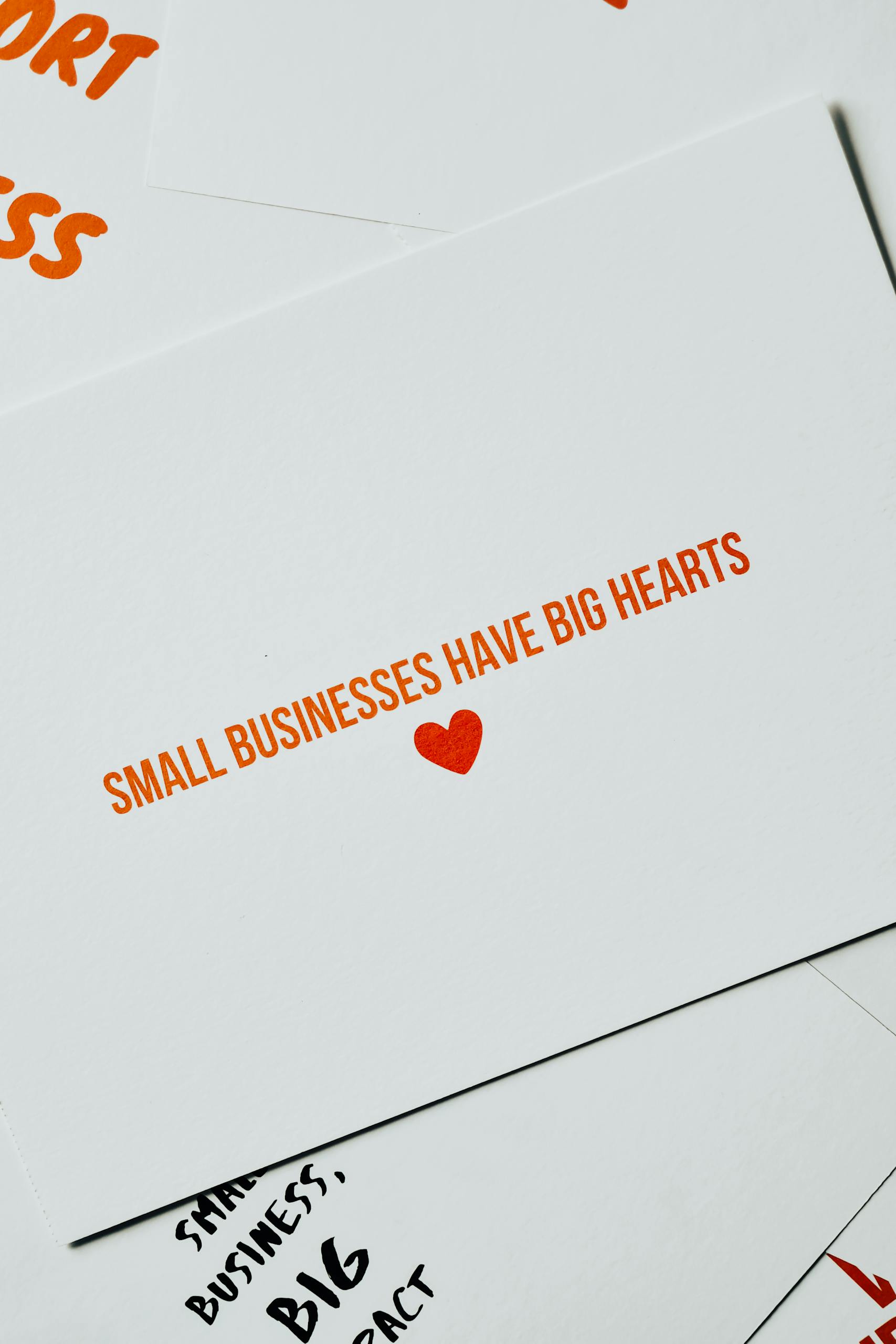 Card with 'Small Businesses Have Big Hearts' message in orange lettering on white background.